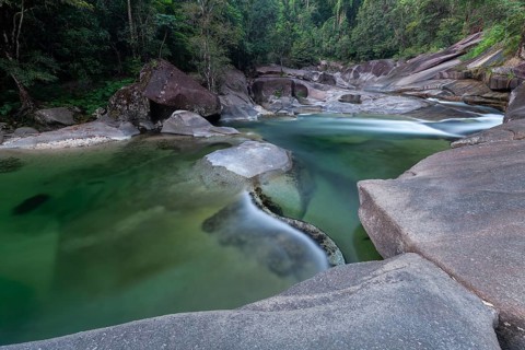 Turquoise blue water between rocks in the tropical rainforest of Babinda Boulders Queensland