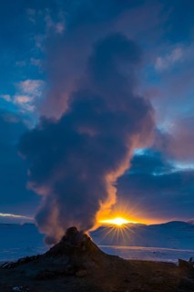 Mud pot with steam source at sunrise, Hverir solfataras field, fumaroles, snow-covered geothermal