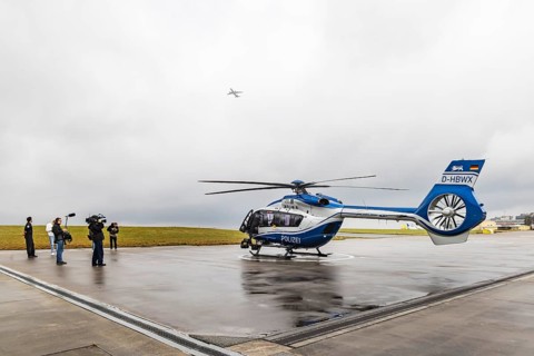 Helicopter from the Baden-Württemberg Police team in front of the hangar at the airport. Airbus