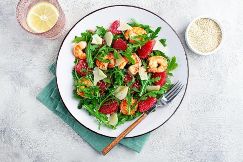 Fresh shrimp salad with arugula, grapefruit, and parmesan served in a bowl
