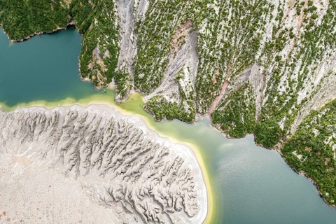 Lake with sandbank and dead trees, crater rim of chaiten volcano, aerial view, Patagonia, Chile