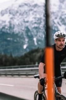 Road bike rider in spring between Lechtal and Tannheimer Tal in front of picturesque scenery of the