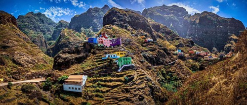 Panoramic view, small settlement, colorful village, picturesque nestled in raw, dramatic mountains