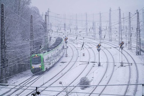 Winter weather, heavy snowfall, railway tracks in front of Essen main station, S-Bahn train, North