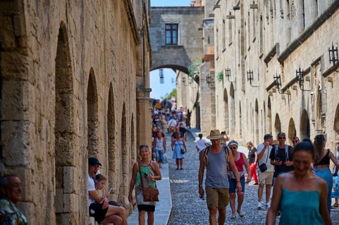 Lively alley of an old town with many people and historic buildings, Knights' Street, Rhodes Old