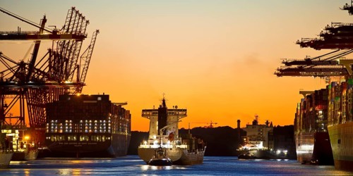 Container ships at the Eurogate container terminal in the evening with an atmospheric sunset,