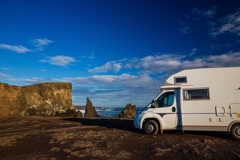 Motorhome parking on the shoreline, south of Sandvik with crashing waves. Rough nature