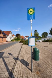 Bus stop Zetel Denkmal, residential building, blue sky, Dammstraße, Zetel, district of Friesland,