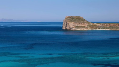 Blue Clipper with cliffs under a clear sky, Venetian Sea Fortress, Gramvoussa, Gramvoussa