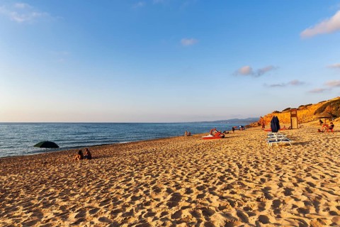 Tourists on the sandy beach, red rocks, holiday by the sea, Spiaggia di Scivu, Arbus, Costa Verde,
