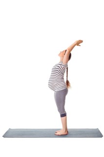 Pregnancy yoga exercise, pregnant woman doing yoga asana Tadasana Mountain pose isolated on white