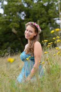Young woman with a floral wreath in her hair outdoors, Germany