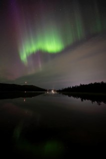 Northern Lights (Aurora borealis) over a forest lake, Gällivare, Norrbotten, Lapland, Sweden,