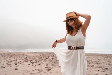 Cute woman in summer clothes on a bay of water in Cabo de Gata, Spain