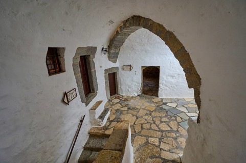 Interior of a historic monastery with stone arches and rustic elements, Inside the monastery, Agiou