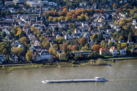 View of the Rhine with cargo ship and Mehlem, district of Bonn-Bad Godesberg, North