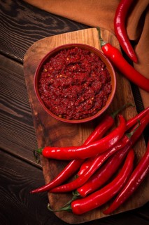 Red, Hot sauce, chili pepper, on a wooden table, no people, vertical, top view