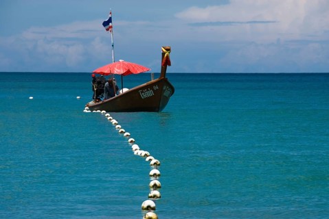 Typical Thai longtail boat on Bang Tao Beach in the northwest of the holiday island Phuket,