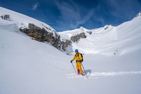 Ski tourers descending in fresh snow, mountain landscape in winter, Bernese Alps, Switzerland
