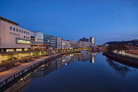 River Saar, modern architecture, trees, fashion shop, Primark, reflections on the water surface,