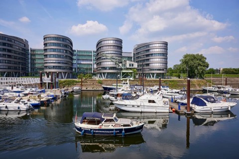 Five Boats office building, marina in the inner harbour and motorboat of a driving school in