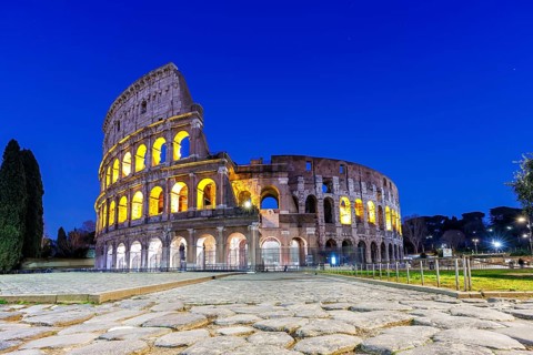 Colosseum ancient amphitheatre at night in Rome, Italy