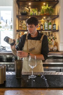 Male bartender barman mixing cocktail drink in bar, Botanist public house, city centre Liverpool