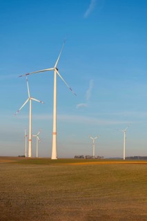 Wind turbines in an open green landscape under a calm sky, solar park, near Ulm, Swabian Alb,