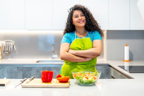 Portrait of a latin young nutritionist female vlogger streaming online from home