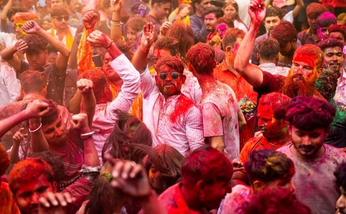 Revellers smear with Gulal or coloured powder and dance to play Holi, the Hindu spring festival of