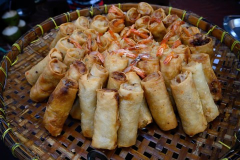 Tasty looking Chinese spring rolls for sale at a street market in Yaowarat Road, Chinatown,