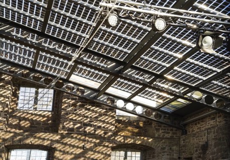 Old castle with modern photovoltaic system as the roof of the concert hall, Wülmersen moated