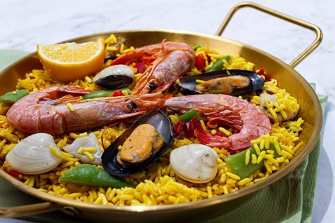Seafood paella, shrimp and mussel risotto, rice, paella in a pan, homemade, natural light, top