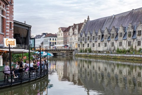 Historic city view by a river with reflective buildings and a relaxed atmosphere, Ghent