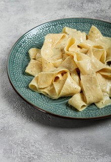 Pasta papardelle in creamy garlic sauce, traditional Italian cuisine, pasta carbonara, homemade, no