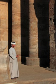 Temple guard in the Kom Ombo temple on the Nile, Africa, Upper Egypt, wears a galabaya, the