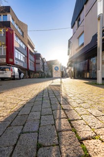Street with cobblestones in the sunshine, long shadows between buildings, Nagold, Black Forest,