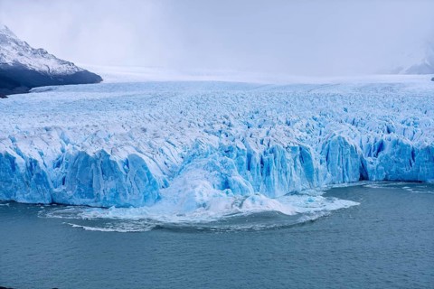 Perito Moreno glacier, breaking ice sheets plunge into Lake Argentino, blue glacial ice with