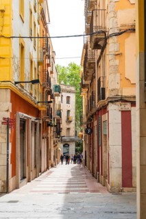 Narrow streets with shops in the city centre of Figueras, Spain