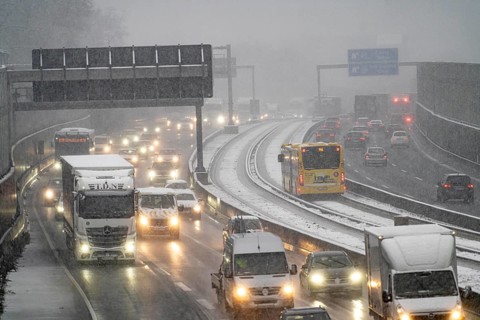 Winter weather, heavy snowfall, traffic jam on the A40 motorway in Essen, local bus, bus lane,
