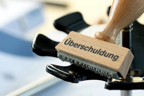 A stamp with the inscription Überschuldung, Federal Republic of Germany