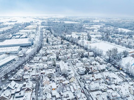 Snowy cityscape with residential buildings and cool winter atmosphere from above, Sindelfingen,