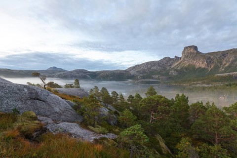 Magical morning fog on Steigtindvatnet in front of the majestic Steigtinden in Norway near Bodø