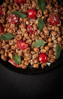 Tuscan pasta with smoked paprika and basil, parmesan cheese, Italian traditional cuisine