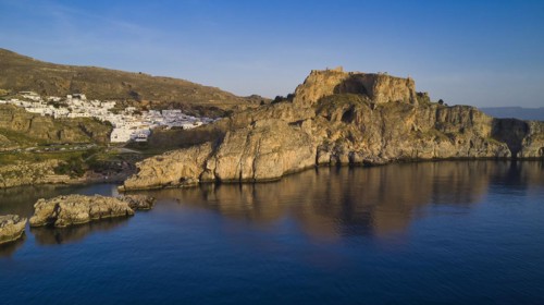 Drone shot, first morning light, Lindos, Acropolis of Lindos, Fortress on a rocky coast above the
