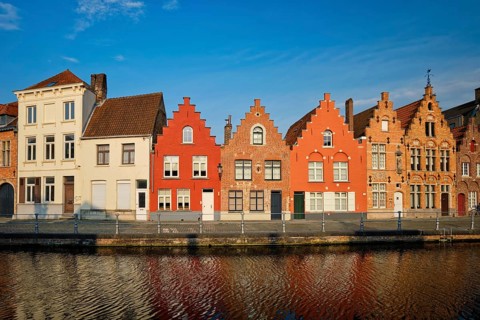 Typical Belgian cityscape Europe tourism concept, canal and old houses on sunset. Bruges (Brugge),