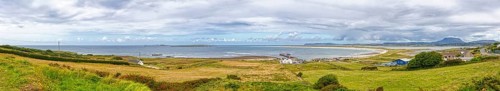 Extensive coastal landscape with sea, meadows and cloudy skies, Magheraroarty