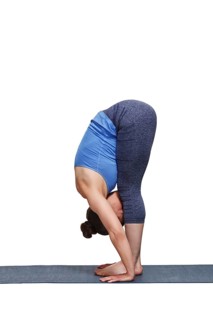 Woman doing yoga asana Uttanasana, standing forward bend pose isolated