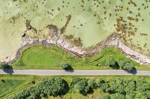 Aerial view of a bay at the Raftsund, road with trees, fjord between Lofoten and Vesteralen, Norway