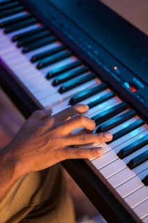 Close-up of the hands of a pianist recording music in studio